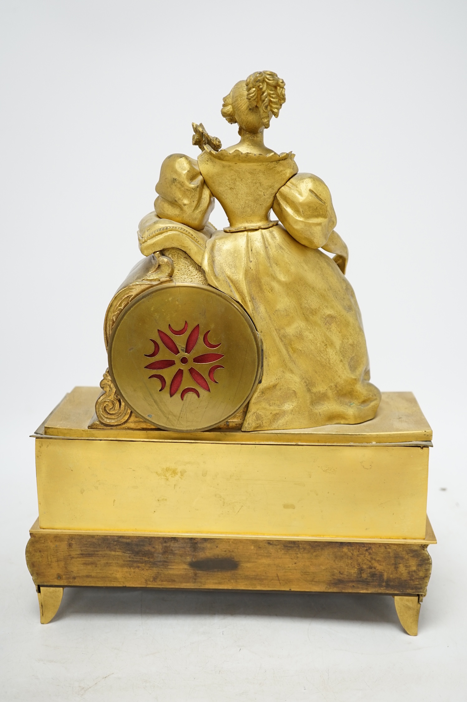 A 19th century French ormolu mantel clock, surmounted with a lady, with key and pendulum, 36cm high. Condition - poor